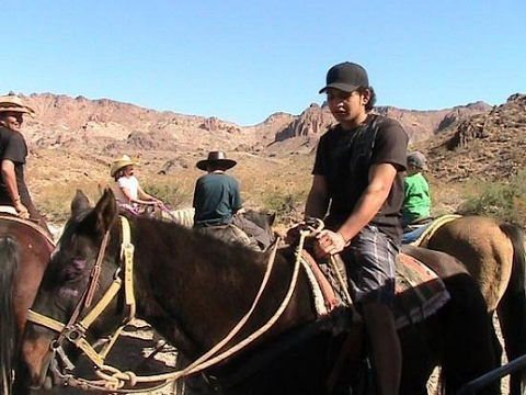 Tourist Riding Horses At The Oatman Stables