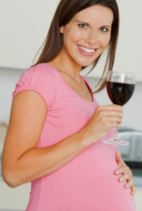 Pregnant lady holding wine