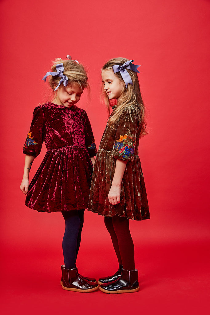 two girls standing in paade mode dresses