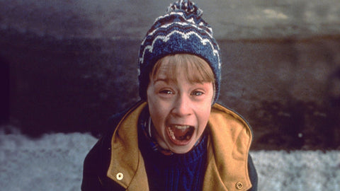Kevin McCallister from Home Alone wearing a winter cap and jacket with a screaming expression on his face.