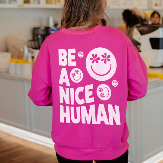 https://cdn.shopify.com/s/files/1/0829/0949/products/be-a-nice-human-graphic-sweater-hot-pink_540x.jpg?v=1684865561