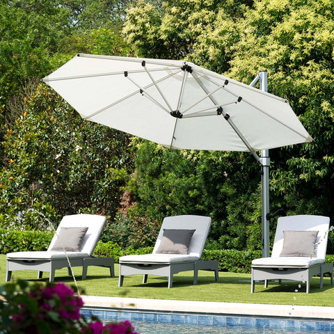 Echo Chaises on the lawn with an umbrella above for shade and protection