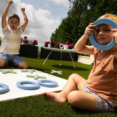 Kids playing with tic tac toe game set