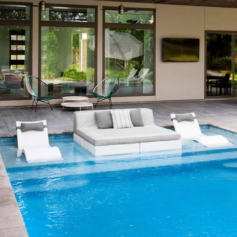 Ledge Lounger in-pool chaises and sectional on a pool ledge