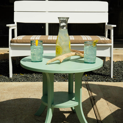 Outdoor dining space with green table and chairs