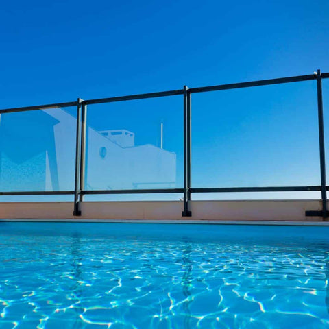 Sky, glass barrier, and pool water