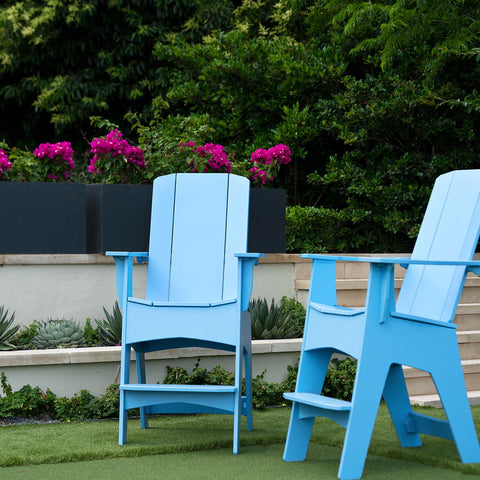 Pair of tall blue Adirondack chairs on the lawn