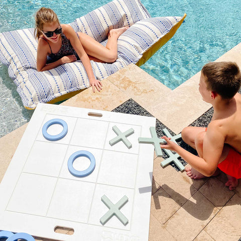Playing giant Tic Tac Toe by the pool