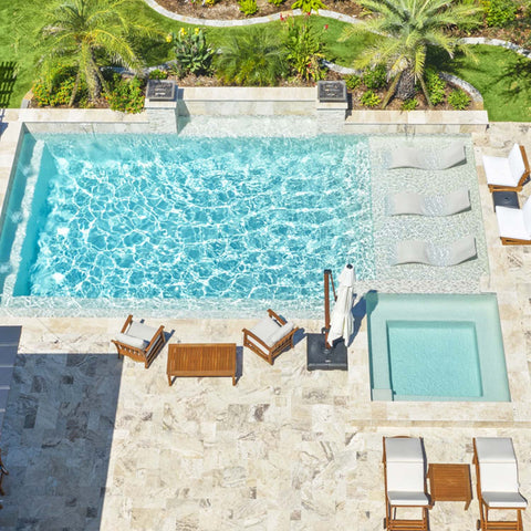 Pool area with in-pool chaise loungers and furniture around the pool