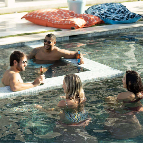 Friends hanging out at a swim-up bar