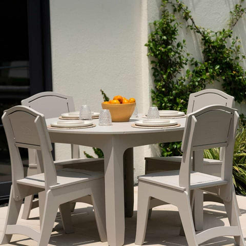 Grey outdoor dining table seating for 4 set and ready for dinner