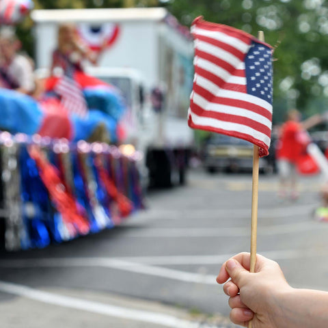Waving small American flag at a parade
