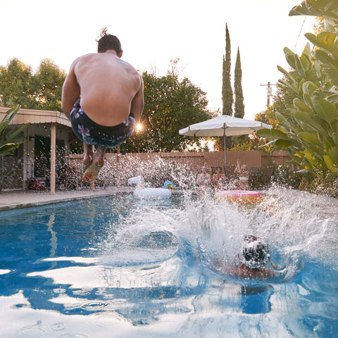 Splashing into the pool during a cannonball contest