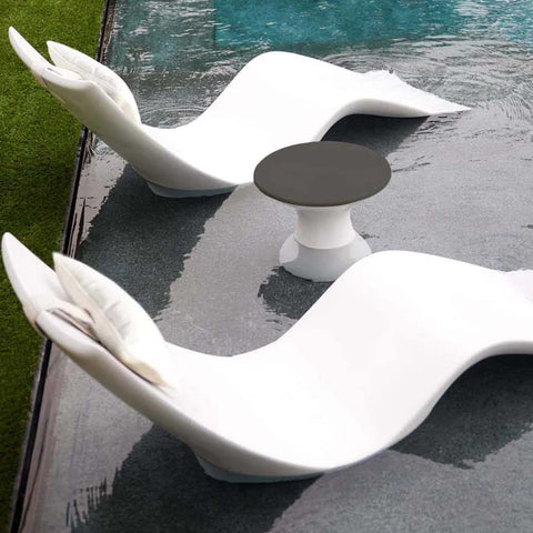 Autograph Chaises with headrest pillows and a side table by Ledge