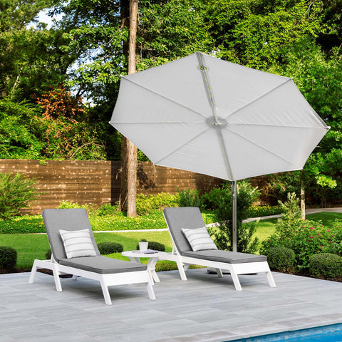 Outdoor chaises under the shade of an umbrella