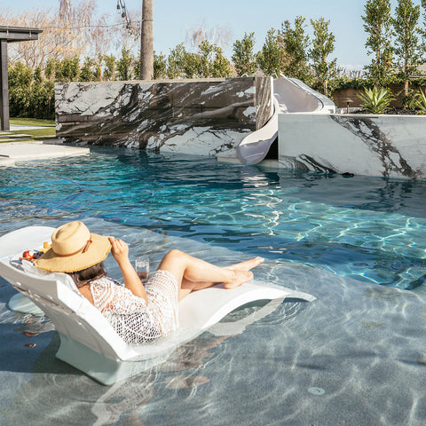 Woman relaxing in her poolside paradise