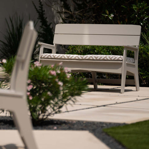 Outdoor bench with cushion for lounging in the garden