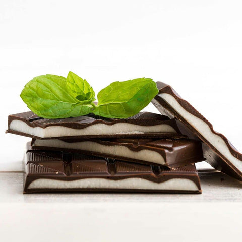 Stack of chocolate squares with white center, and mint leaf on top