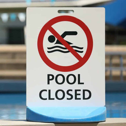 "Pool Closed" sign in front of pool
