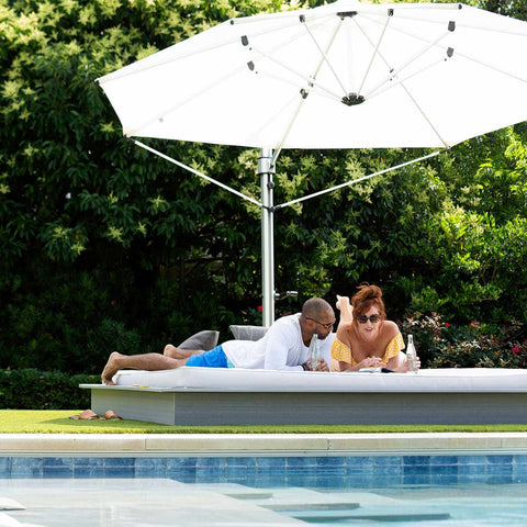 Hanging out on outdoor daybed under an umbrella