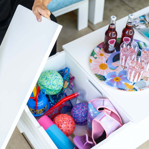 Pool toys stored inside Mainstay Storage Coffee Table and drinks on the surface of the table