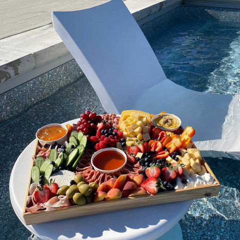 Charcuterie board on an in-pool side table