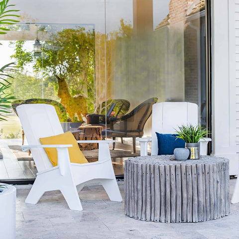 White adirondack chairs with colorful pillows