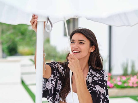 Woman closing an umbrella at the end of the day