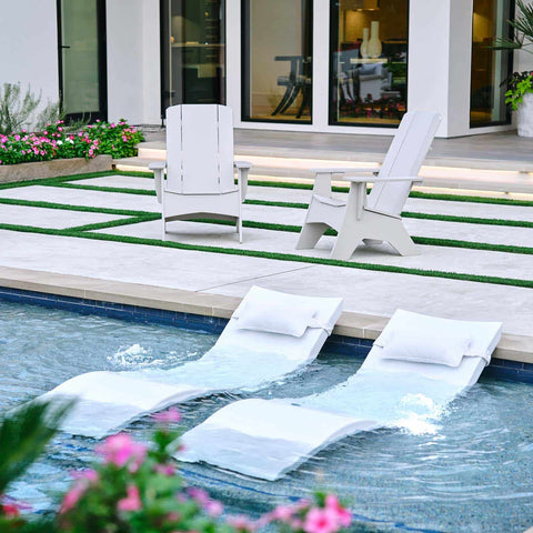 Ledge Signature Chaises in the pool