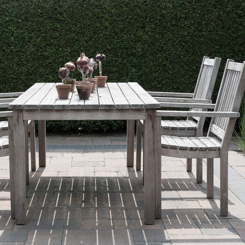 Worn and weathered wooden outdoor dining table and chairs