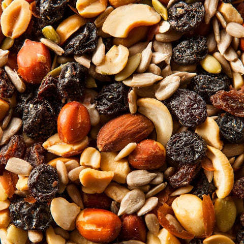 Close up of trail mix consisting of various nuts, seeds, and raisins
