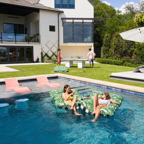 Woman relaxing on Laze Pillows in the pool