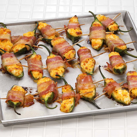 Bacon-wrapped cheddar jalapeño poppers on a tray