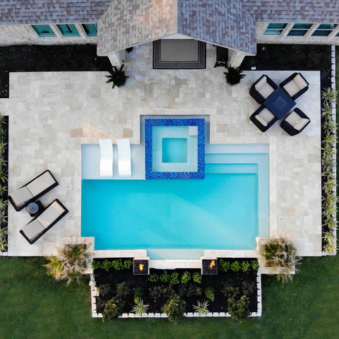 Aerial view of a backyard with a pool and luxurious outdoor furniture