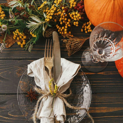 Rustic table setting with flowers in orange and brown hues