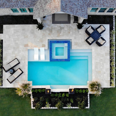 Overhead shot of backyard pool and patio with Ledge Lounger products