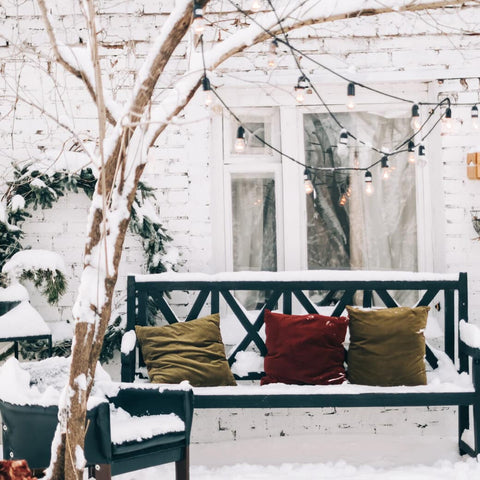 Backyard loveseat and chair covered in snow