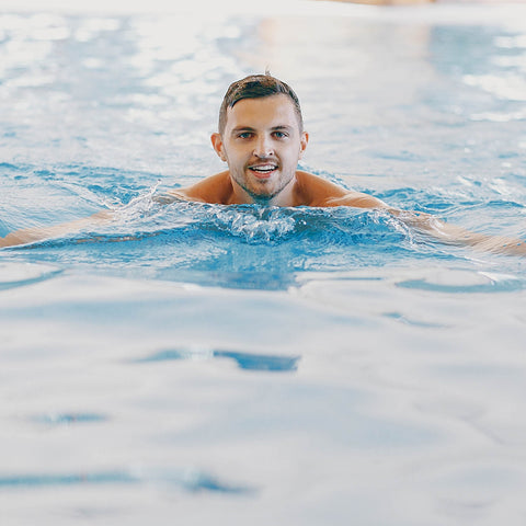 Man swimming through the water