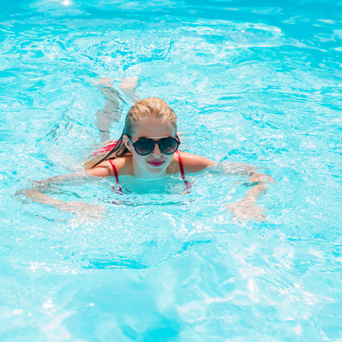 Woman swimming through the water