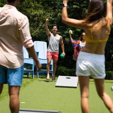 Two couples playing cornhole against one another