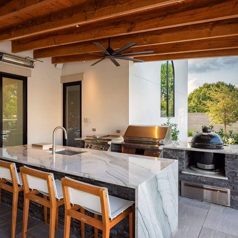 Backyard kitchen with barstools at counter