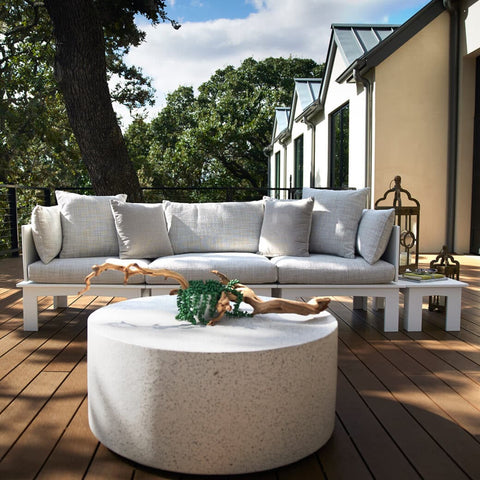 Ottoman with cushions and coffee table on backyard deck