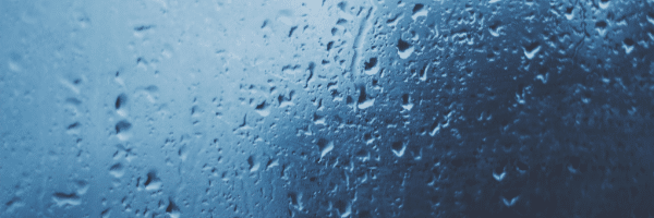A close up of a window with rain drops on it.
