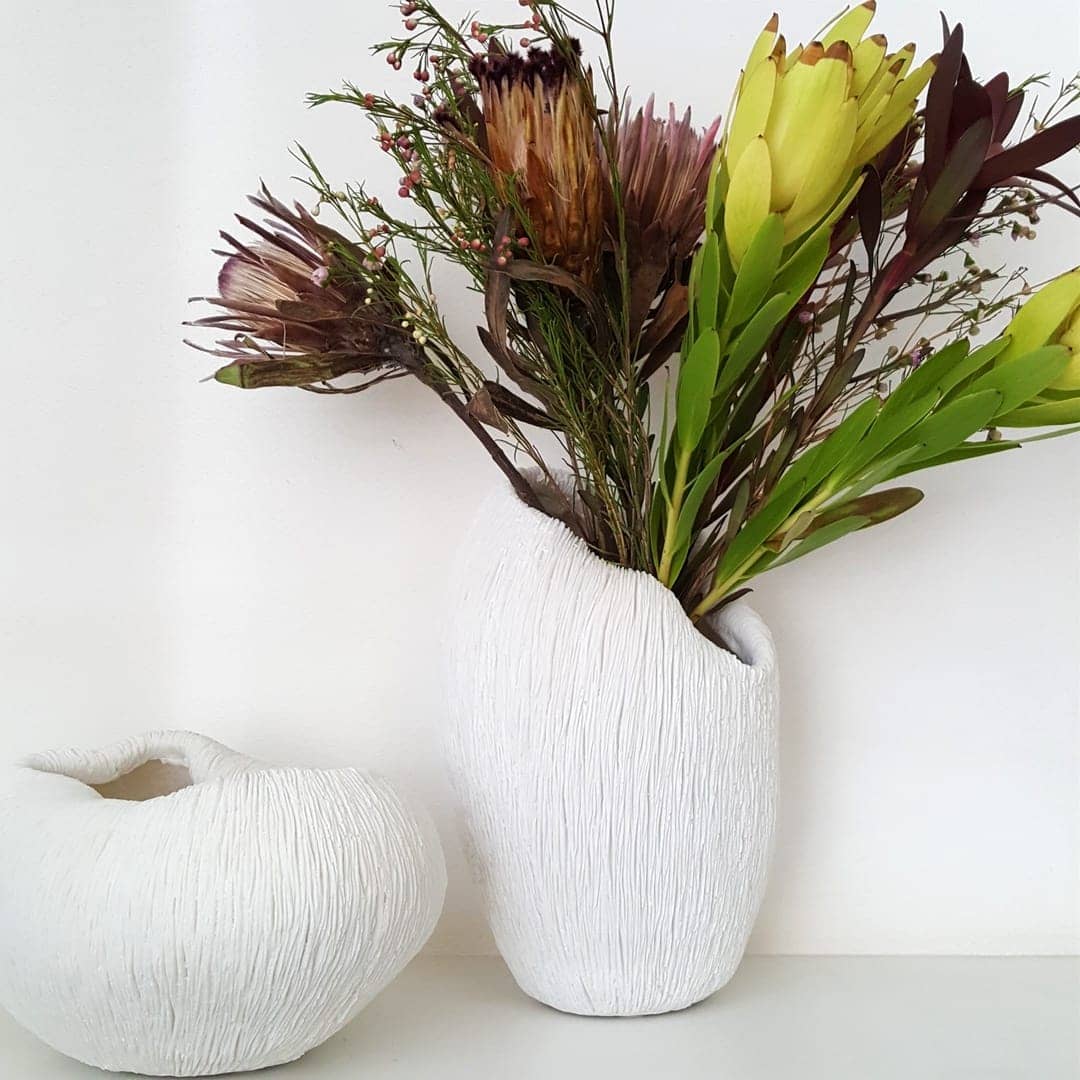 Coral White Vase with flowers next to the coral bowl