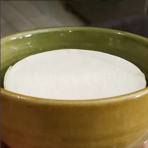 Shaving soap fitted into a bowl