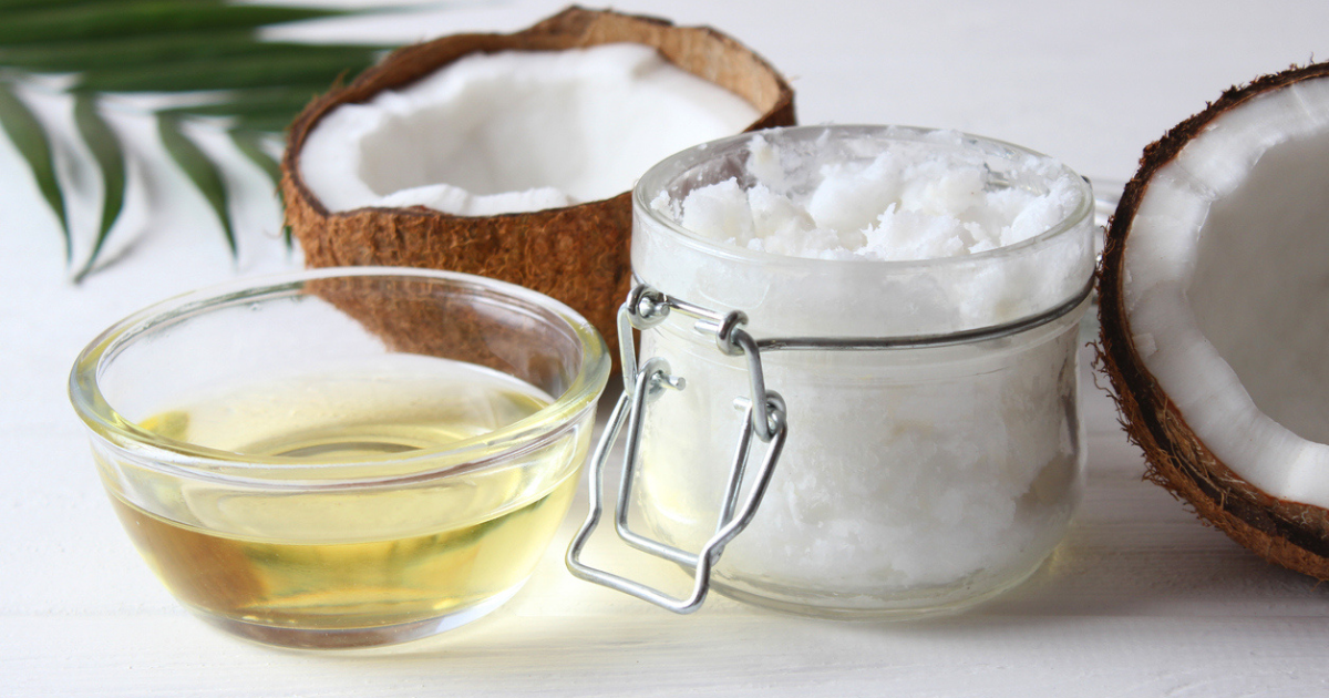 An opened coconut along with solid and liquid coconut oil on a white background.