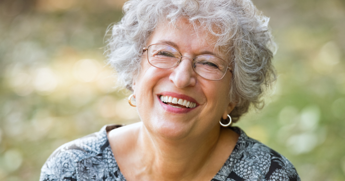 A older senior women smiling after treating her lice naturally with Hair Fairies.