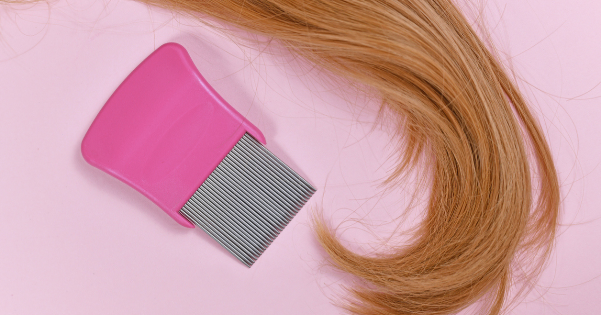 A curl of blonde hair next to a lice pick comb.