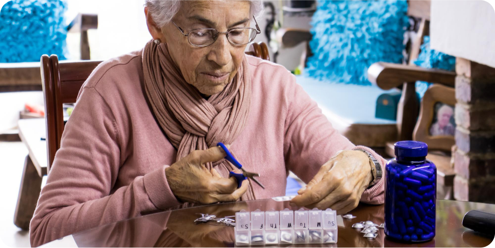 elderly person using a pill organizer