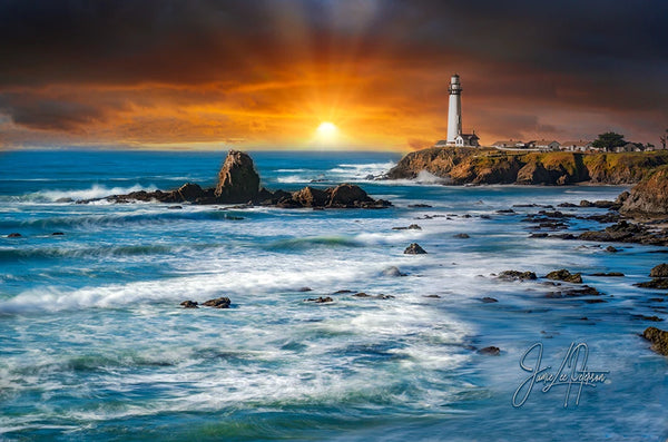 The historic Pigeon Point Lighthouse stands as a beacon of light against a backdrop of a fiery sunset and churning sea, symbolizing guidance and hope amidst the wild coastal landscape.